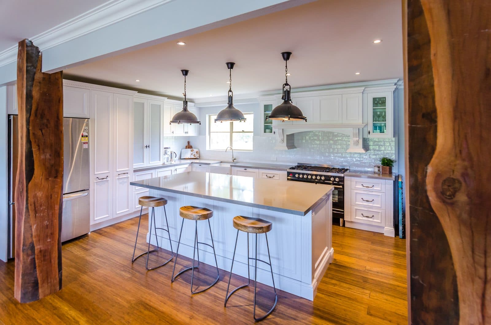 Warm timber with stone benchtops - custom industrial kitchen in Greater Sydney by Kitchen Envy